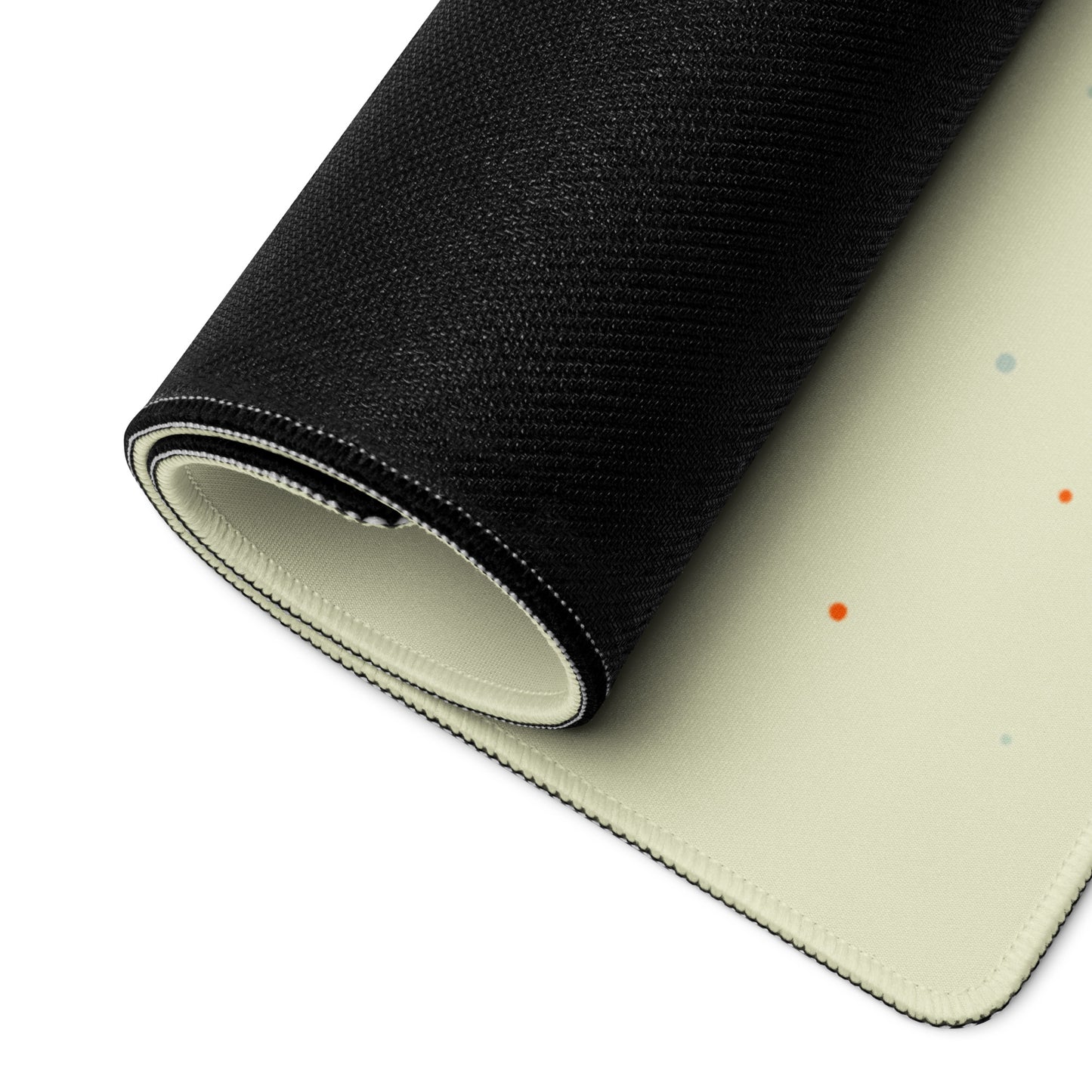 A 36" x 18" desk pad with a space shuttle blasting off on it rolled up. Beige in color.