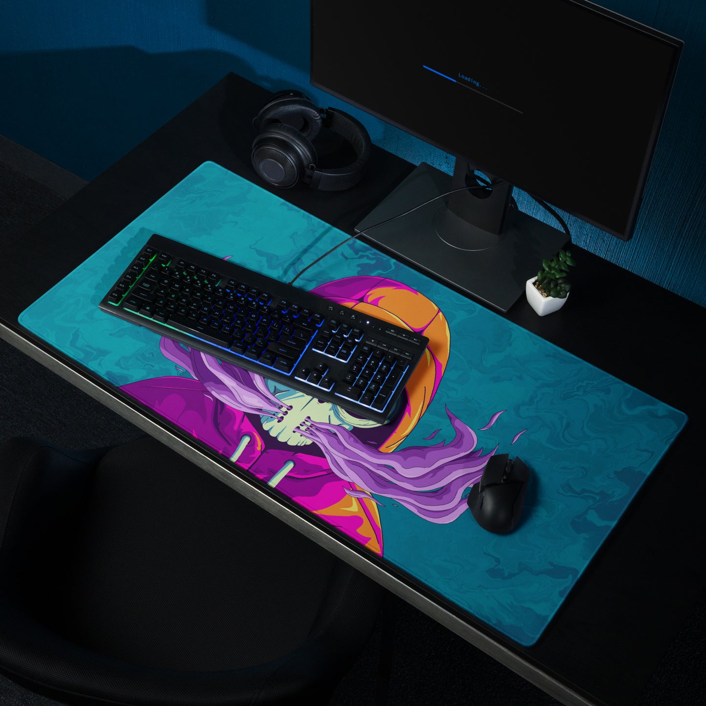 A 36" x 18" desk pad with a man wearing a skull gas mask breathing smoke out from it shown on a desk setup. Blue in color.