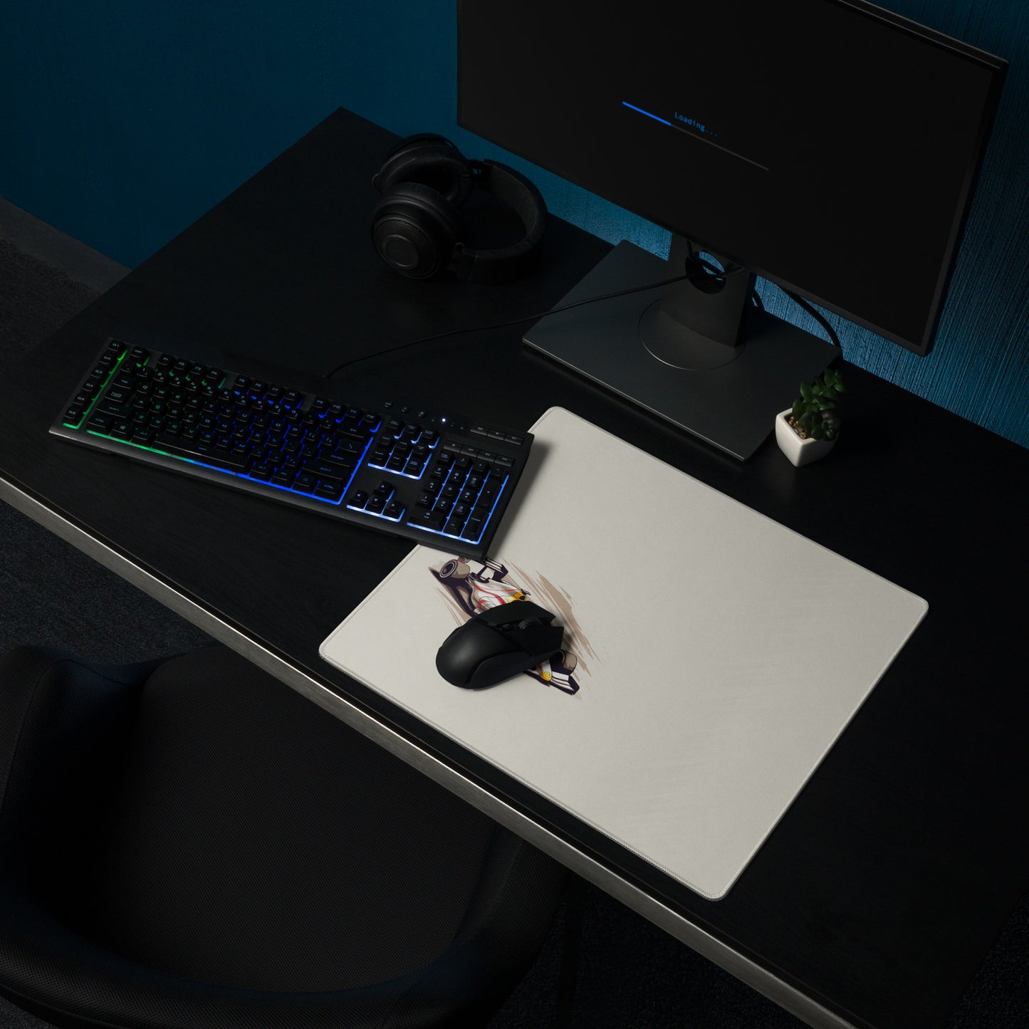 An 18" x 16" mouse pad with a fast formula one car on the left side shown on a desk setup. Beige in color.