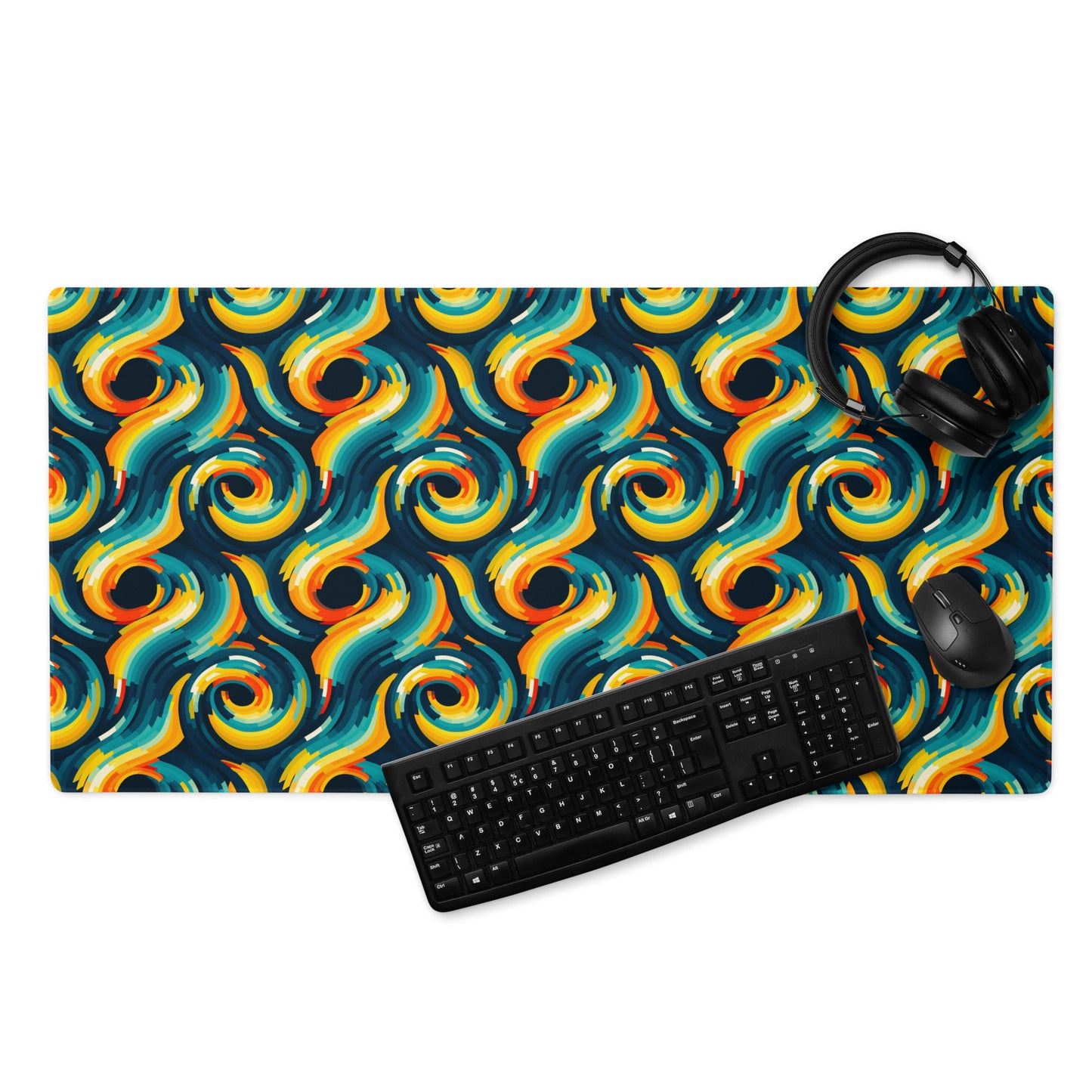 A 36" x 18" desk pad with swirls all over it displayed with a keyboard, headphones and a mouse. Yellow and Blue in color.