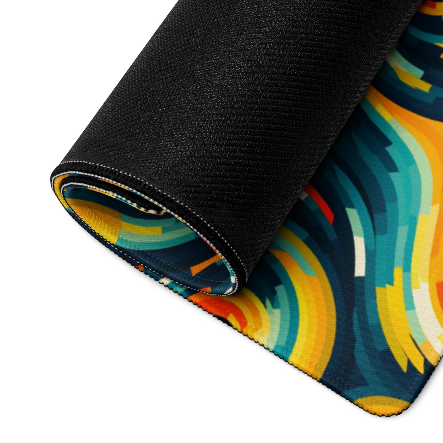 A 36" x 18" desk pad with swirls all over it rolled up. Yellow and Blue in color.