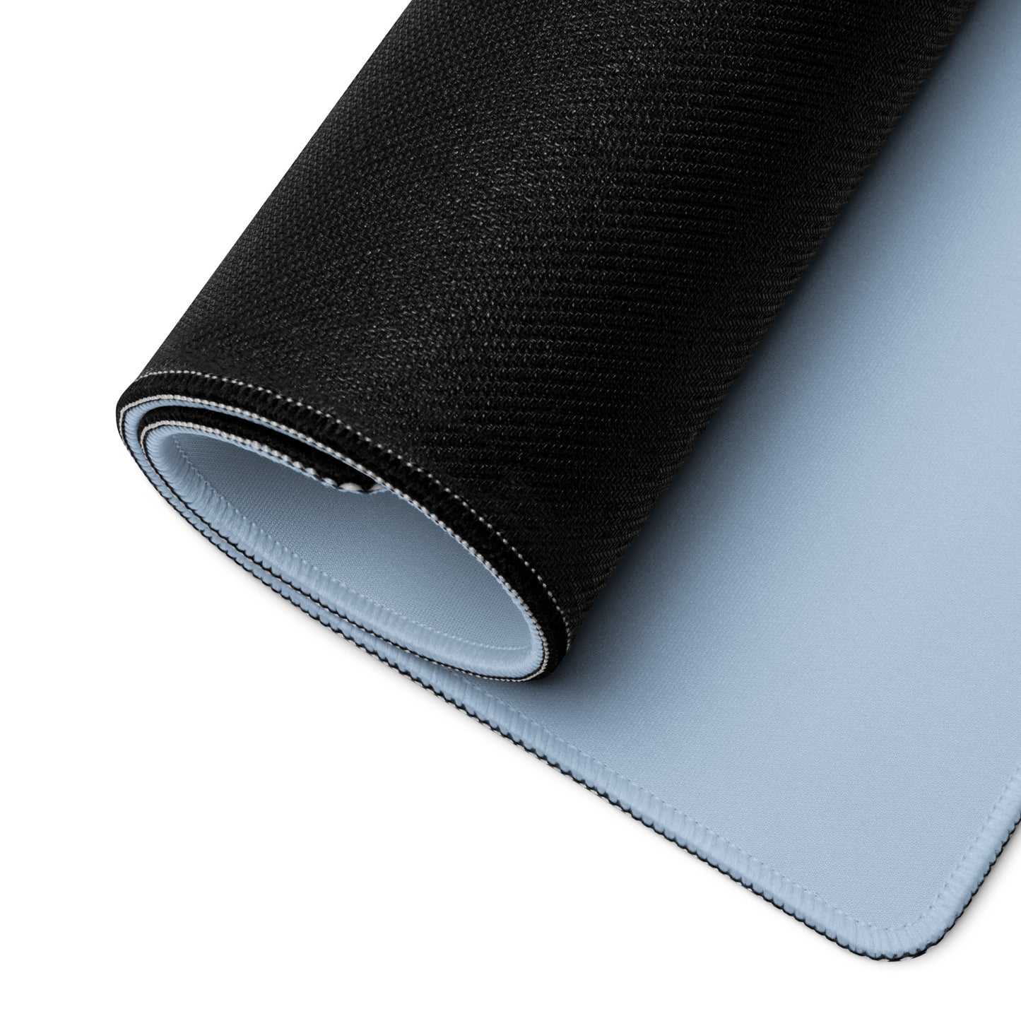 A 36" x 18" desk pad with a cute sheep eating ice cream on it rolled up. Blue in color.
