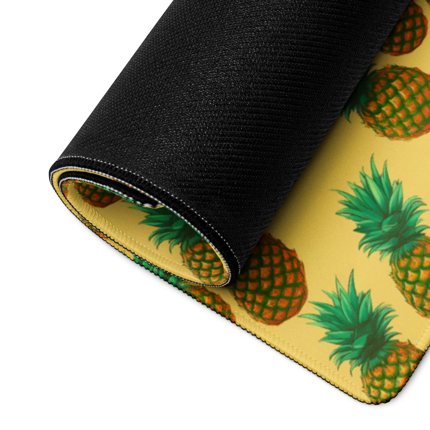 A 36" x 18" desk pad with pineapples all over it rolled up. Yellow in color.