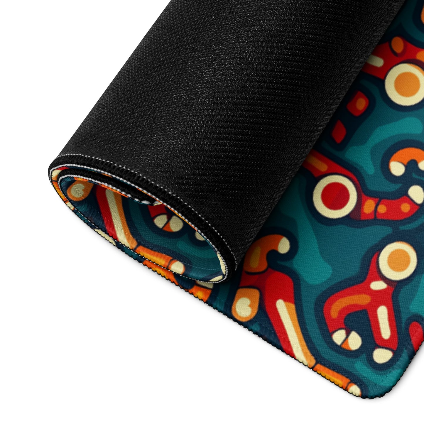 A 36" x 18" desk pad with abstract line art on it rolled up. Red, Orange and Teal in color.