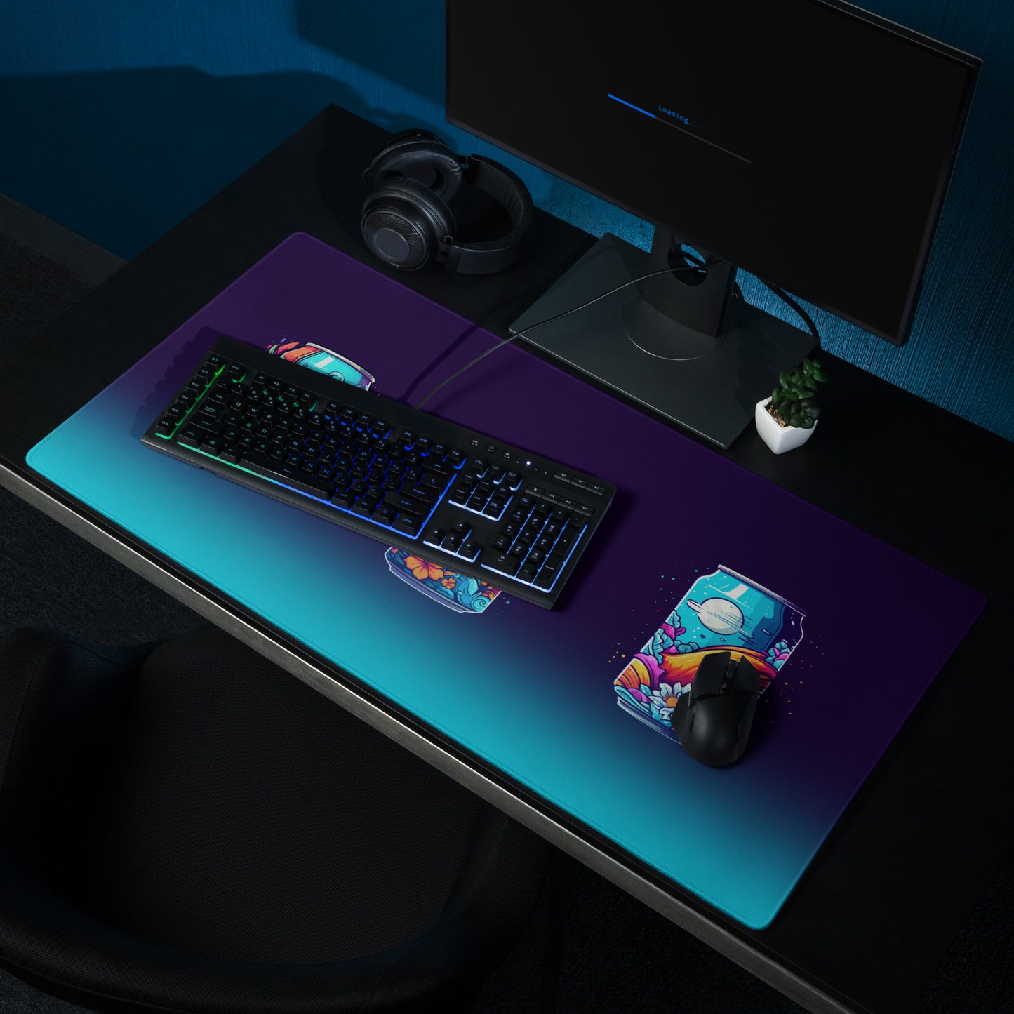 A 36" x 18" desk pad three soda cans that have a floral, wave, or space design sitting on a desk.