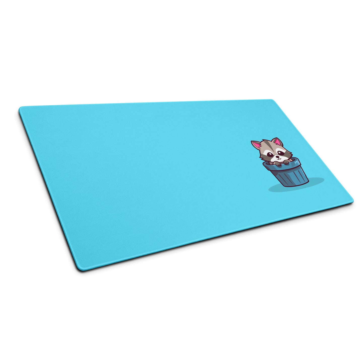 A gaming desk pad with a kawaii raccoon in a garbage can on a blue background sitting at an angle.