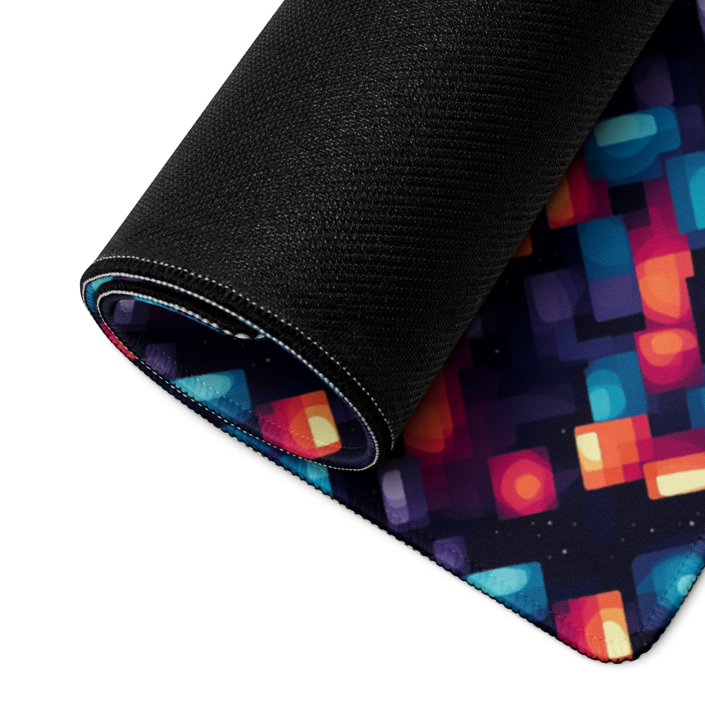 alt text- A 36" x 18" desk pad with blue and orange abstract pattern rolled up.