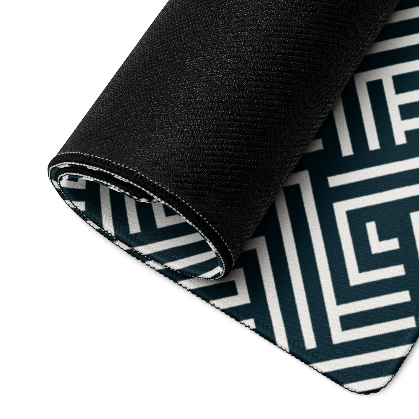 An endless maze gaming desk pad rolled up.