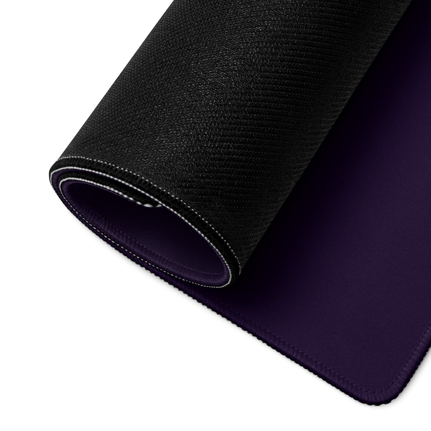 A 36" x 18" purple desk pad with three people with gas masks in a forest rolled up.