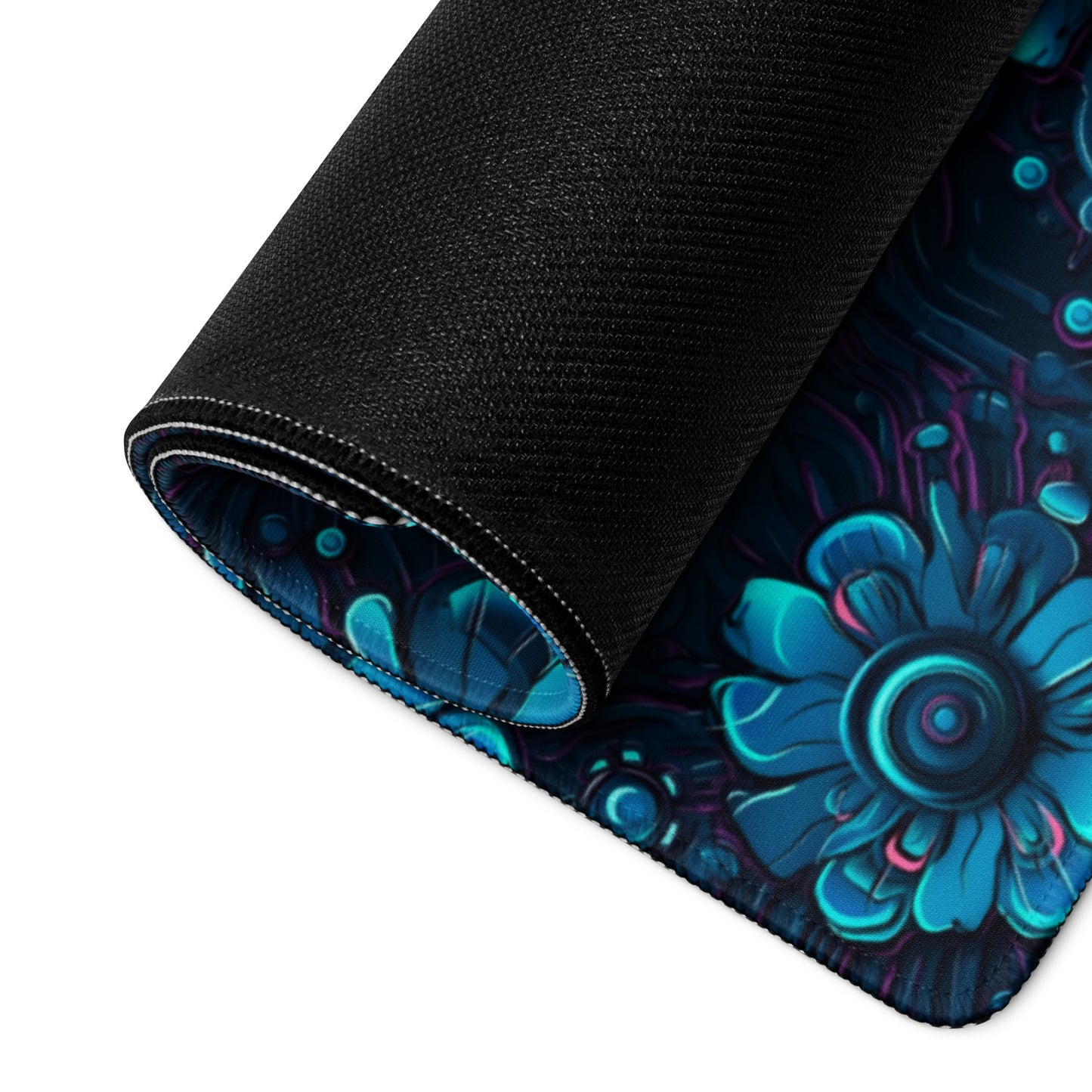A 36" x 18" desk pad with a blue robotic floral pattern rolled up.