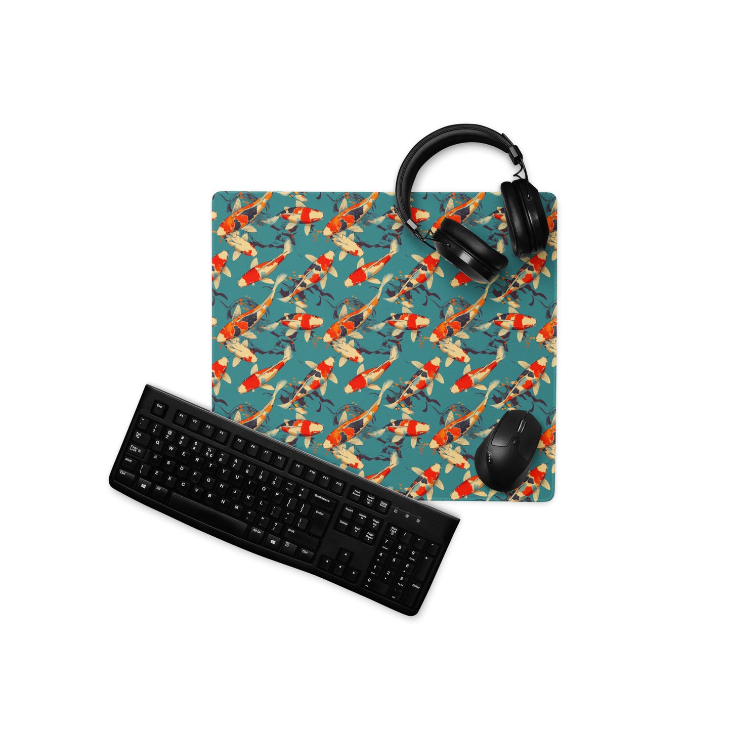 An 18" x 16" gaming desk pad with red koi fish on a blue background. A keyboard, headphones, and mouse sit on top of it.
