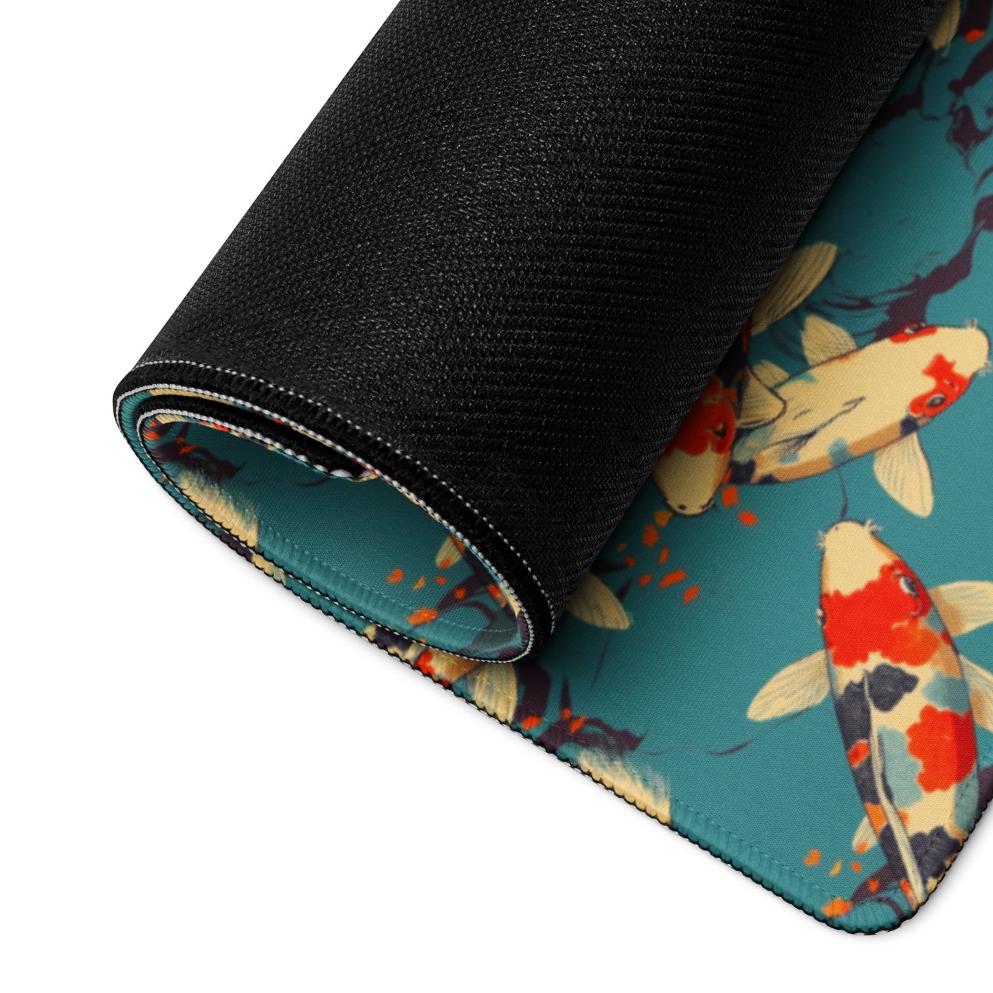 A gaming desk pad with red koi fish on a blue background rolled up.