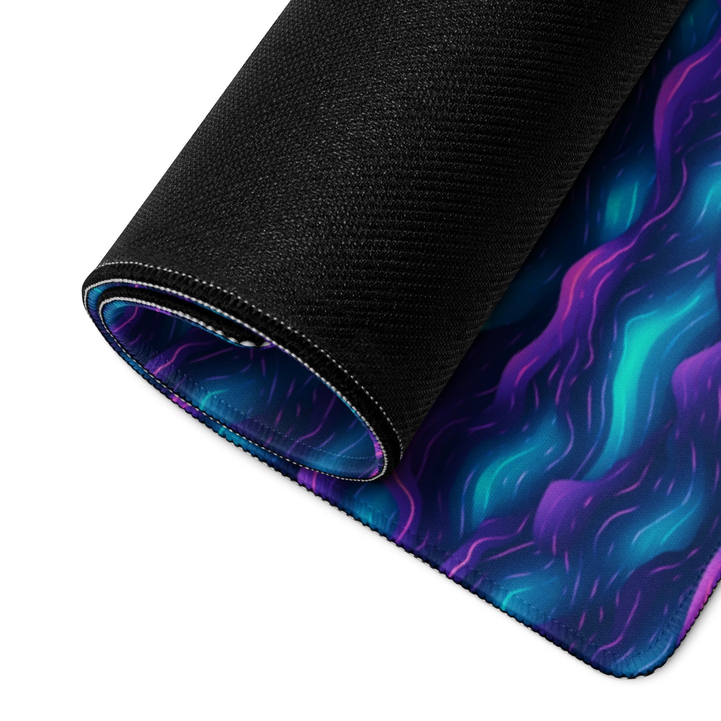 A 36" x 18" desk pad with blue and purple wave pattern rolled up.