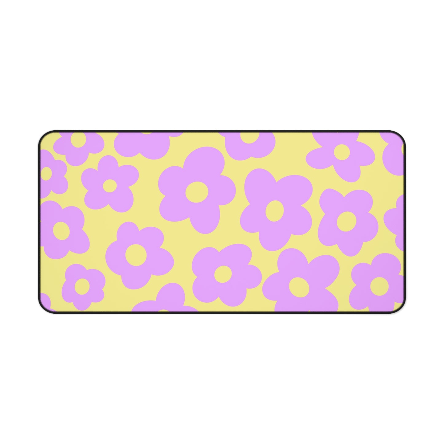 A 31" x 15.5" desk mat with purple flowers on a yellow background.