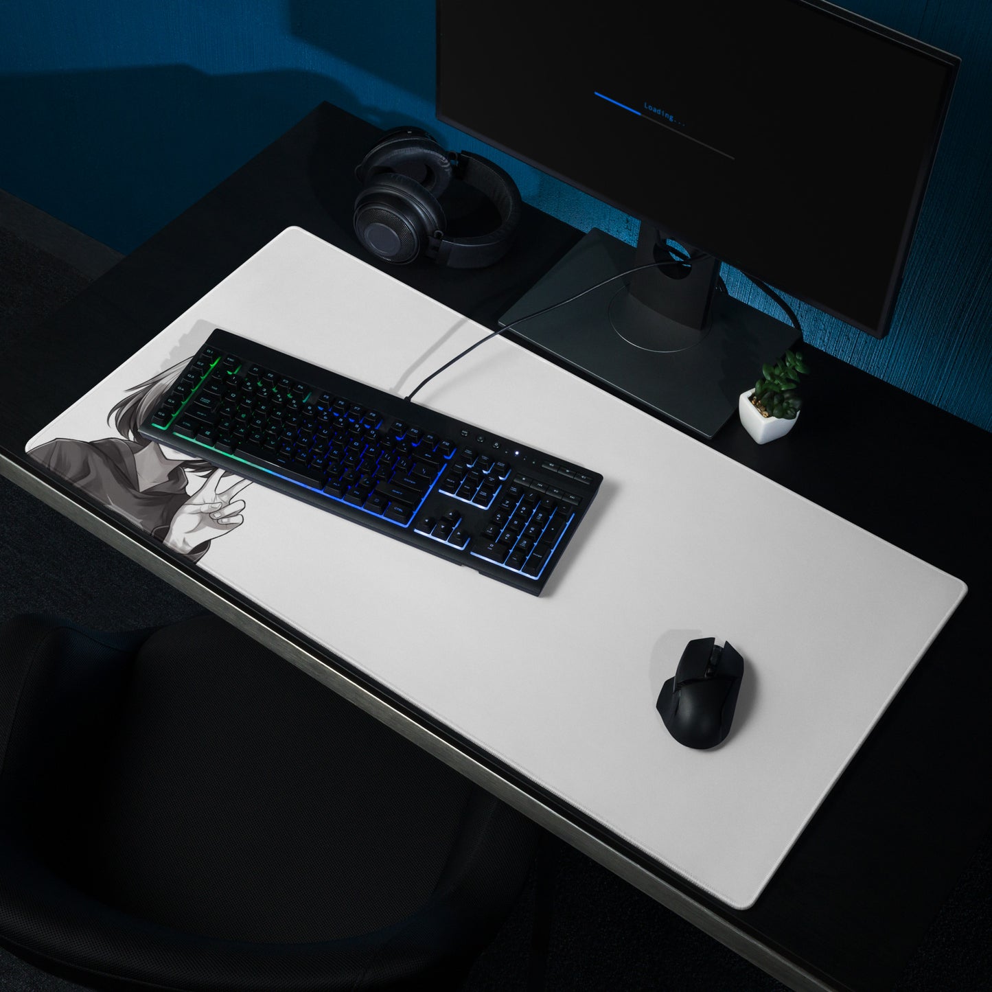 A 36" x 18" black and white desk pad with an anime girl making a peace sign sitting on a desk.