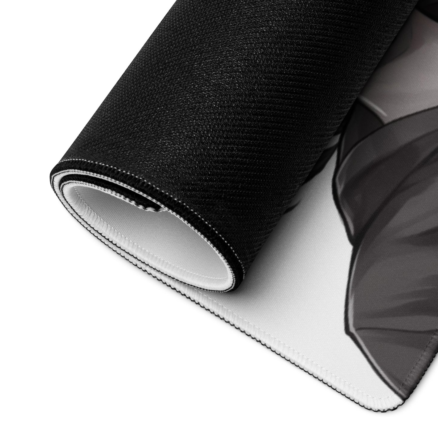 A 36" x 18" black and white desk pad with an anime girl making a peace sign rolled up.
