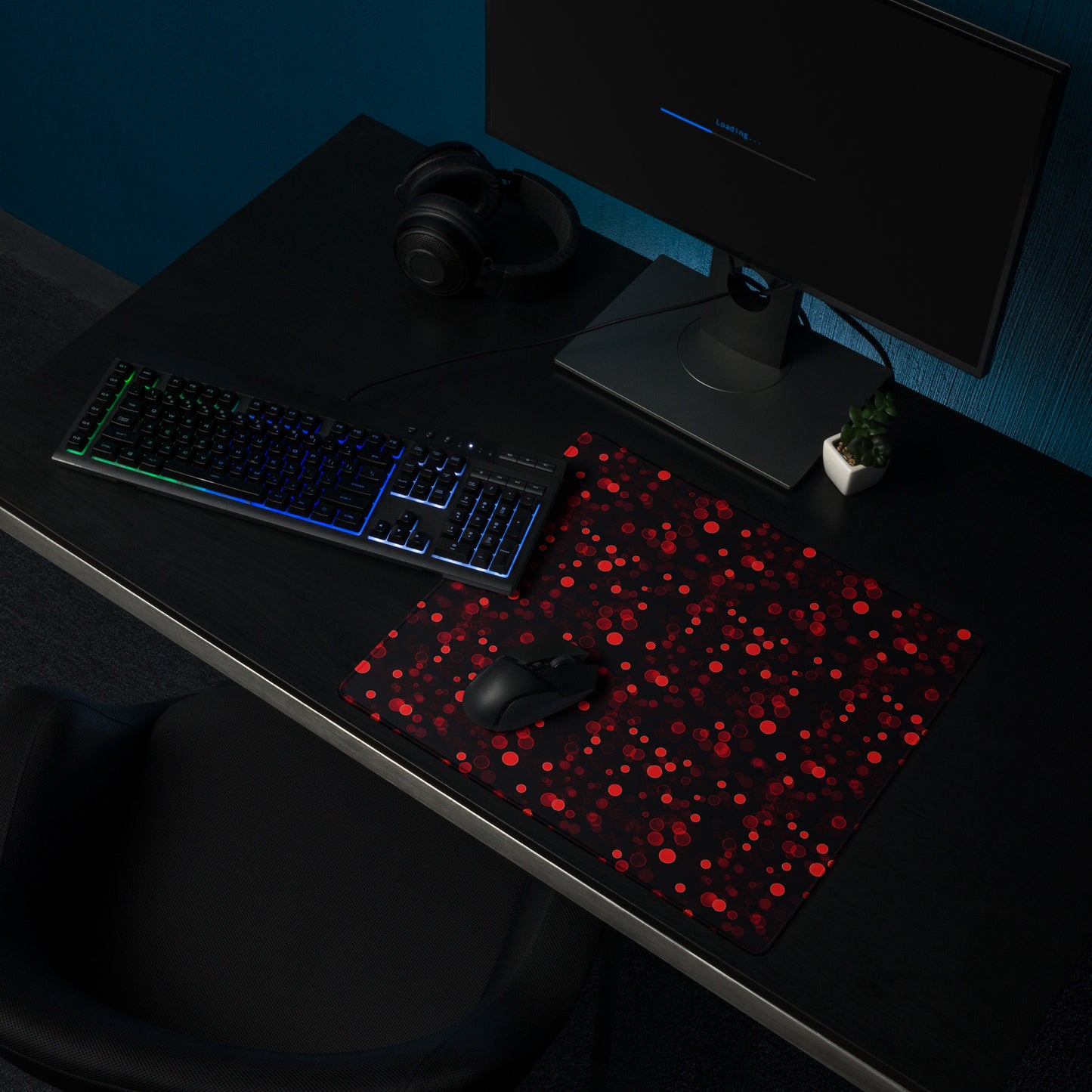 A 18" x 16" desk pad with red polka dots sitting on a desk.