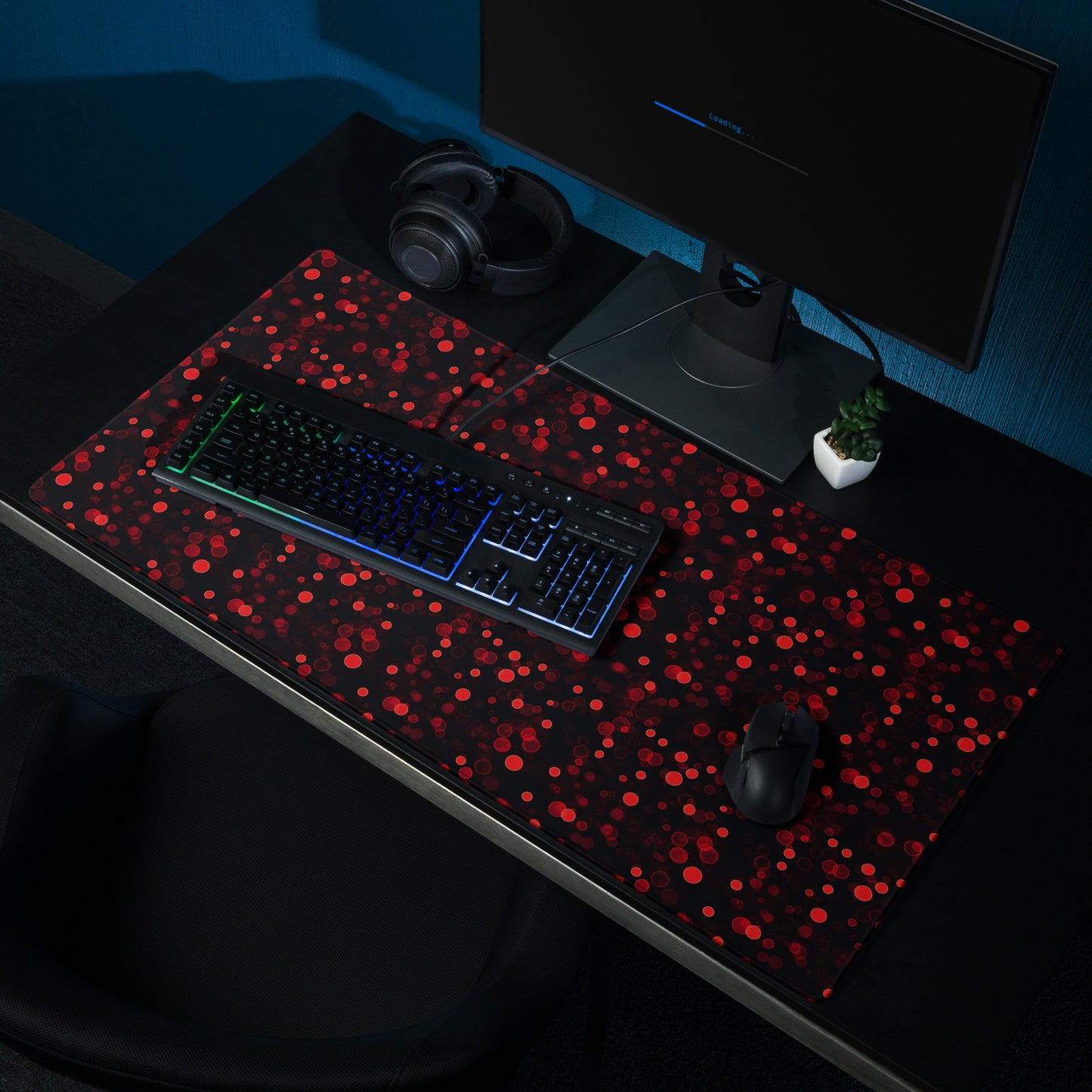 A 36" x 18" desk pad with red polka dots sitting on a desk.