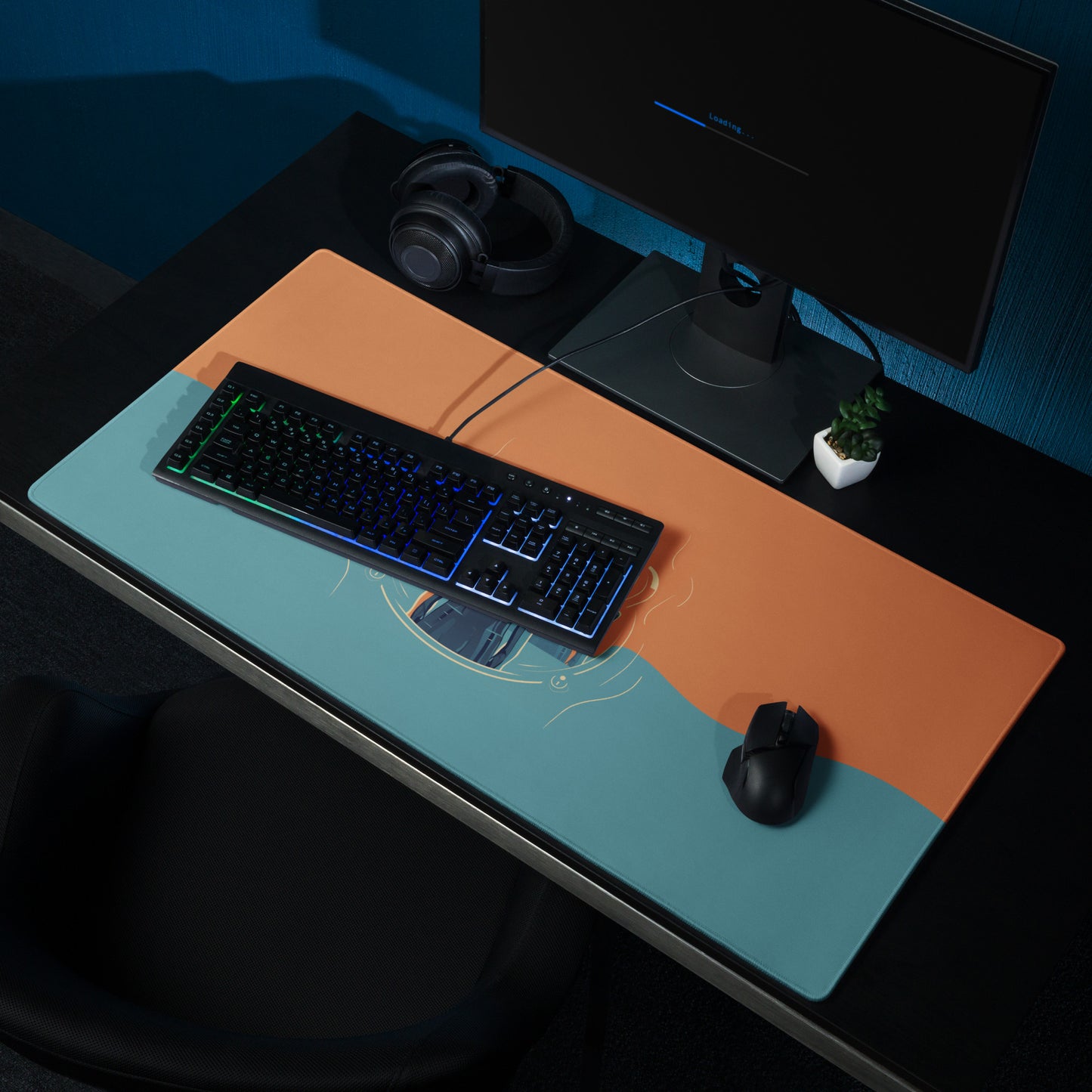 A 36" x 18" orange and blue desk pad with three robed figures sitting on a desk.