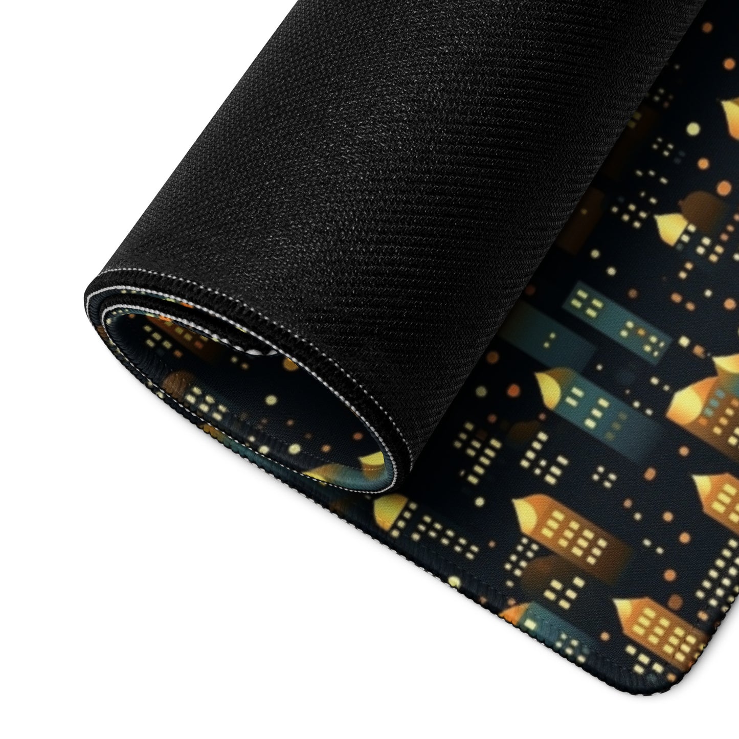 A 36" x 18" desk pad with a stary city pattern rolled up.