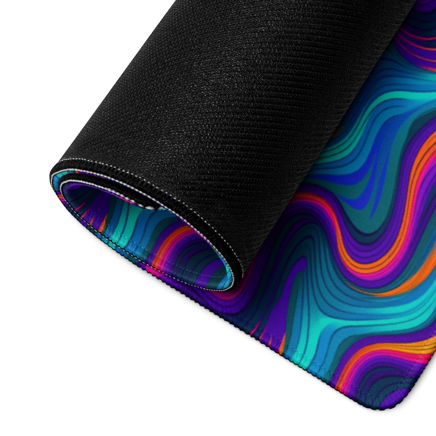 A 36" x 18" desk pad with blue and orange wavy pattern rolled up.