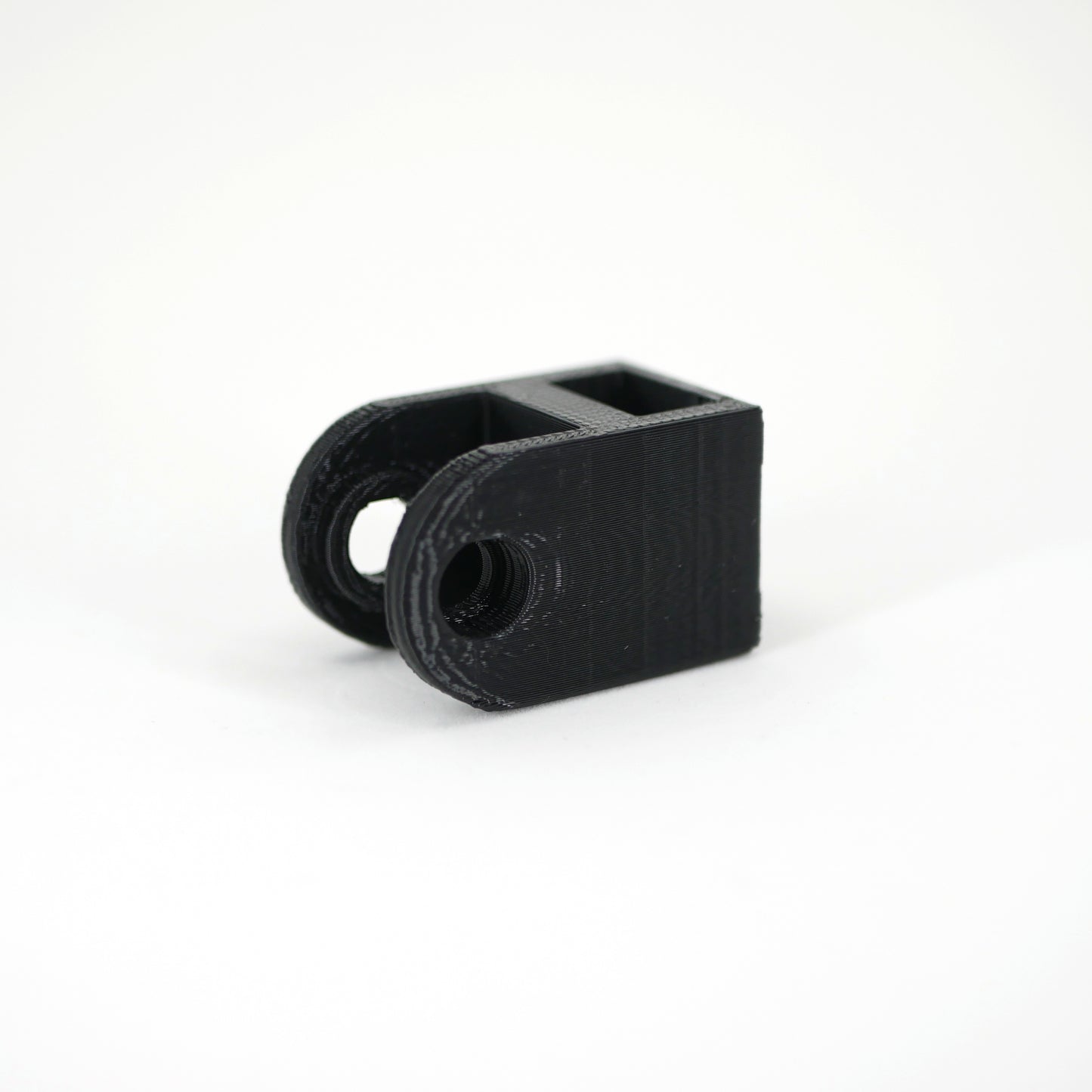 A black HyperX DuoCast microphone mount adapter.