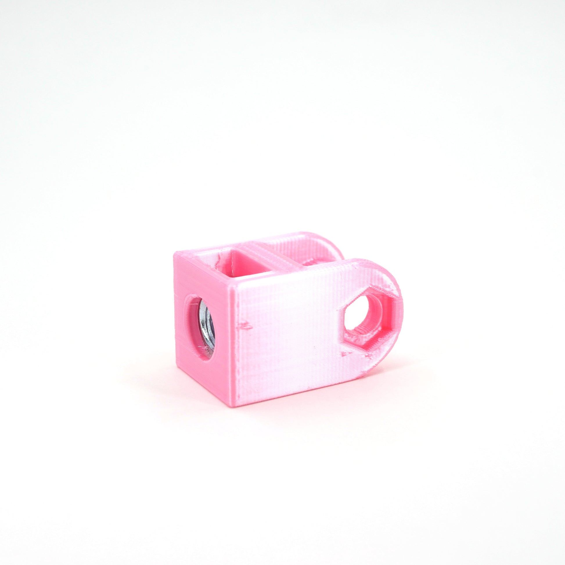 A pink HyperX DuoCast microphone mount adapter sitting at an angle.