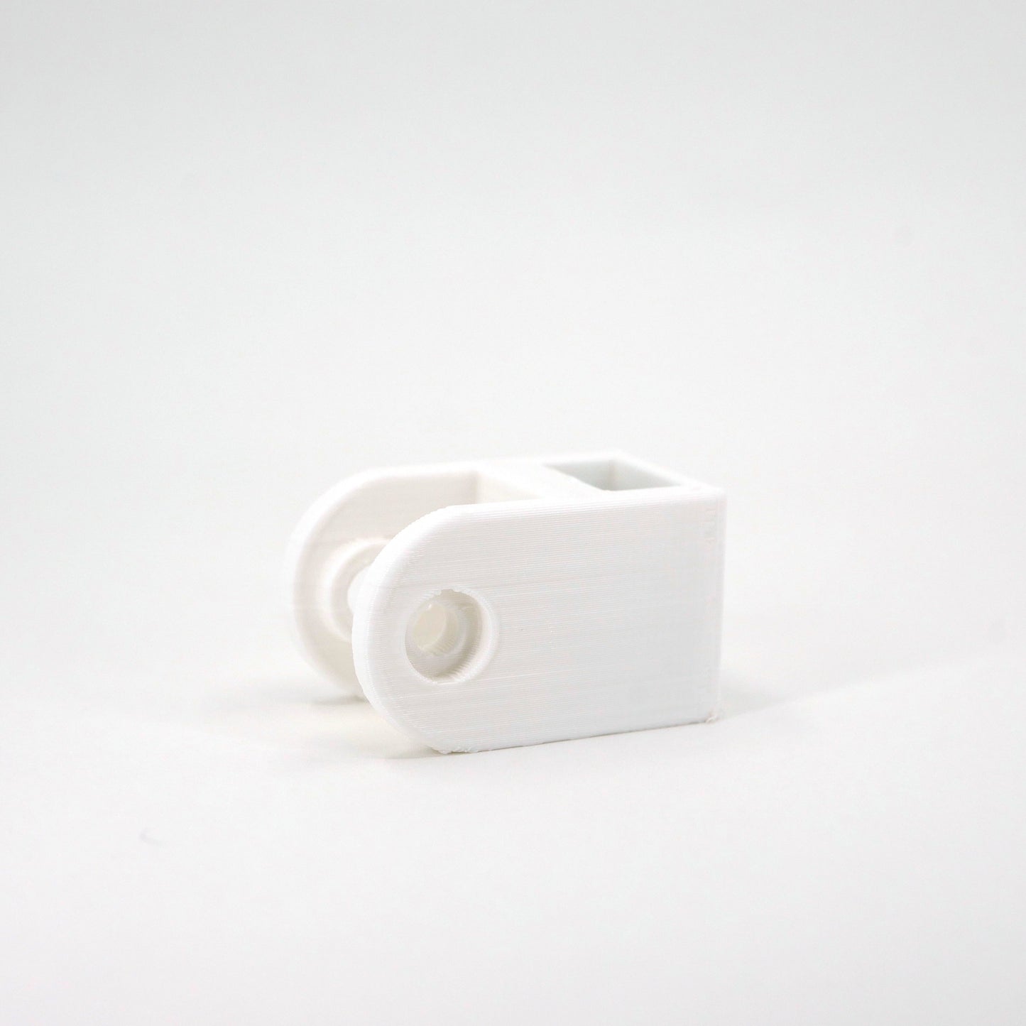 A white HyperX SoloCast microphone mount adapter.