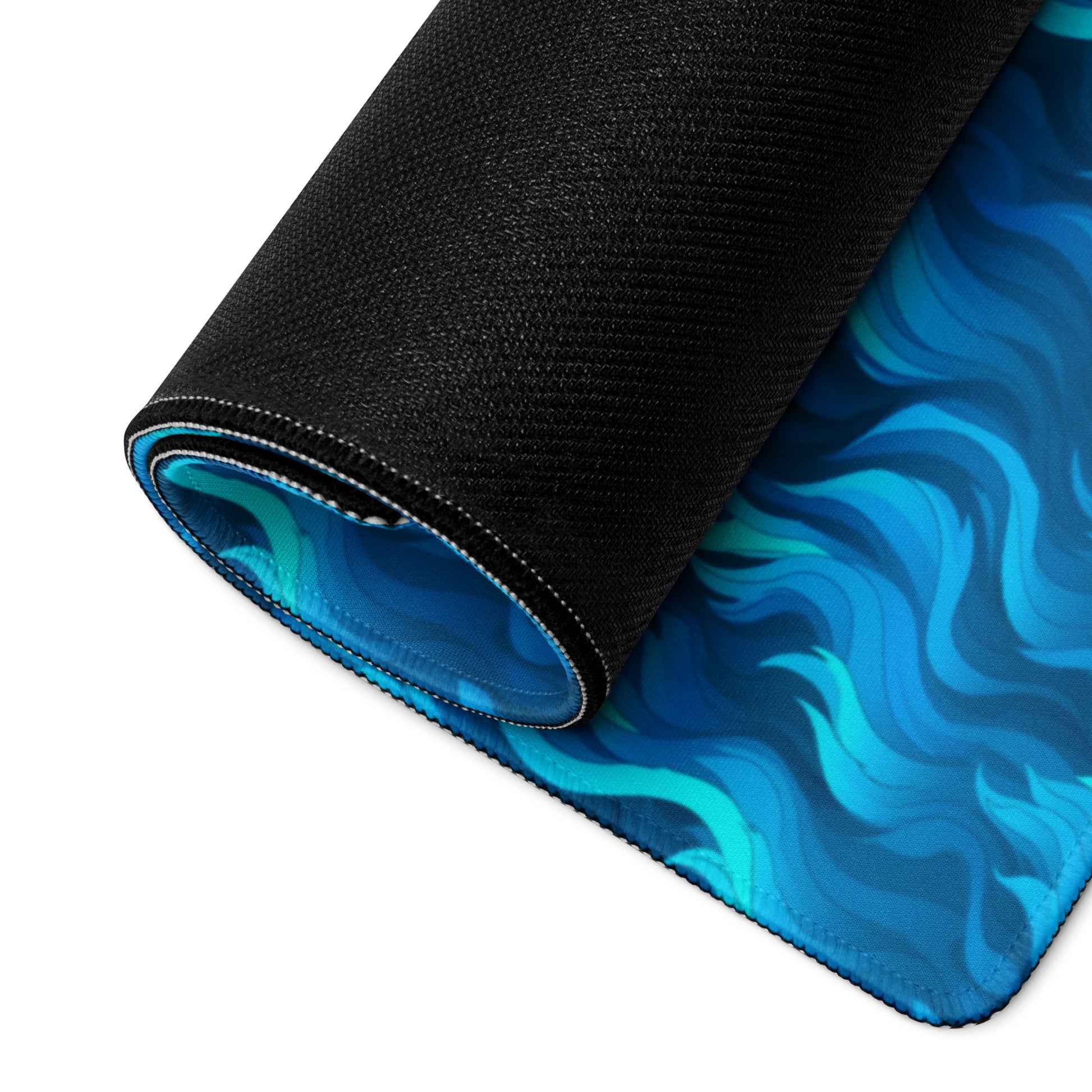 A 36" x 18" desk pad with a wavy flame pattern on it rolled up. Blue in color.
