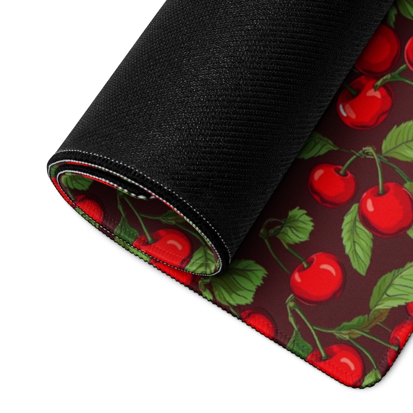 A 36" x 18" desk pad with cherries all over it rolled up. Red in color.A 36" x 18" desk pad with cherries all over it rolled up. Red in color.