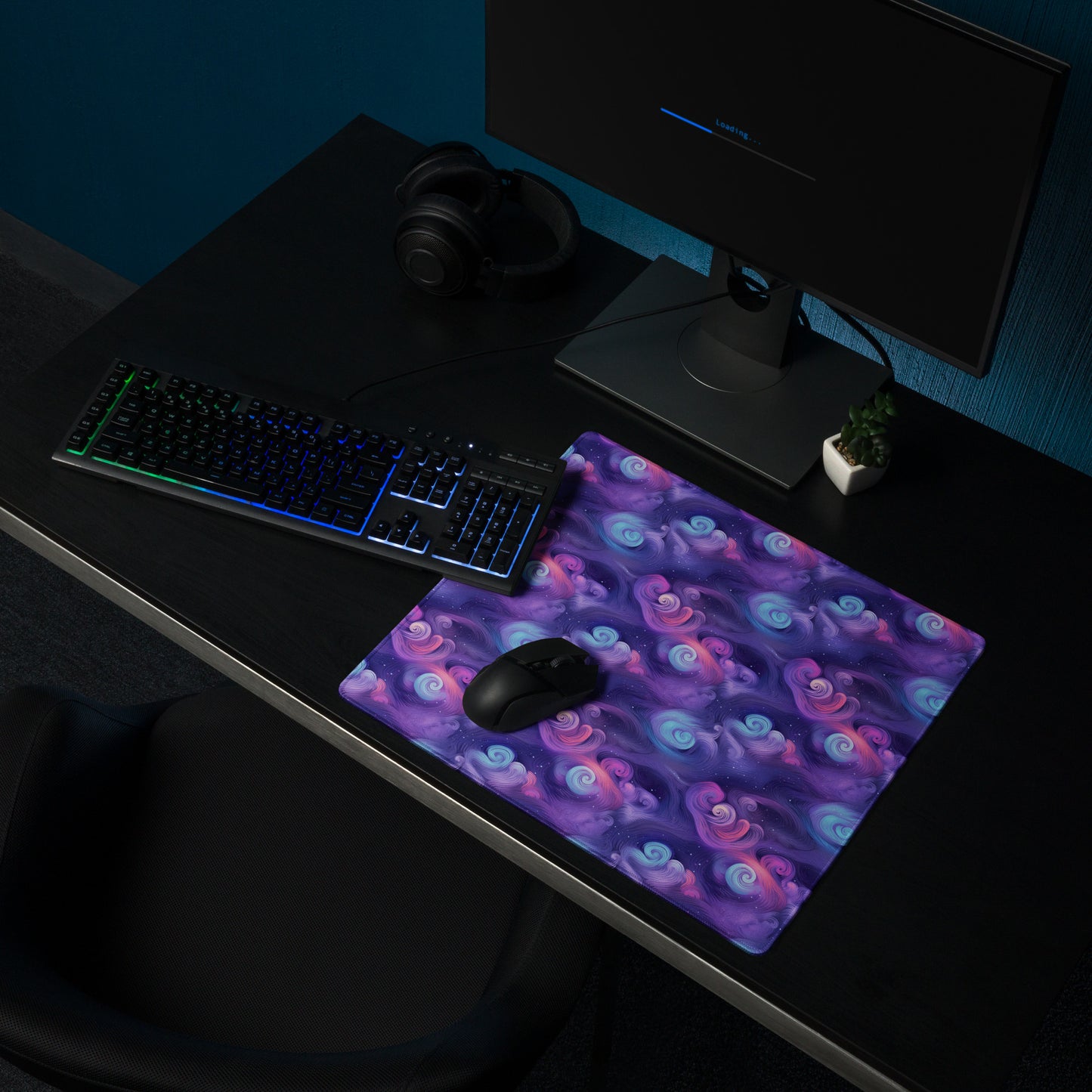 A 18" x 16" desk pad with fluffy clouds and stars on it shown on a desk setup. Blue and Purple in color
