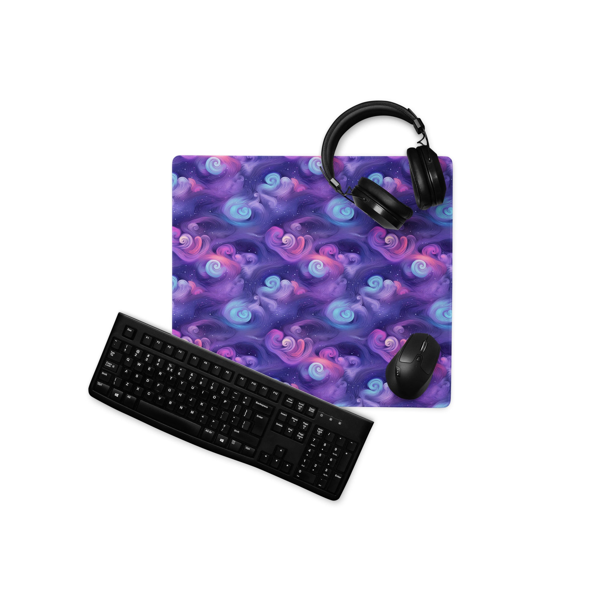 A 18" x 16" desk pad with fluffy clouds and stars on it displayed with a keyboard, headphones and a mouse. Blue and Purple in color