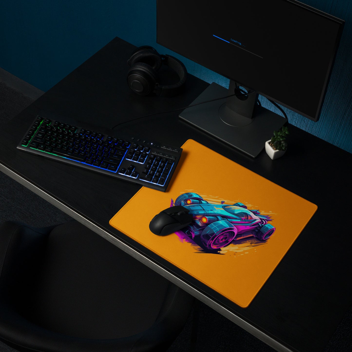 An 18" x 16" mouse pad with a futuristic race car displayed on a desk setup. Orange in color.