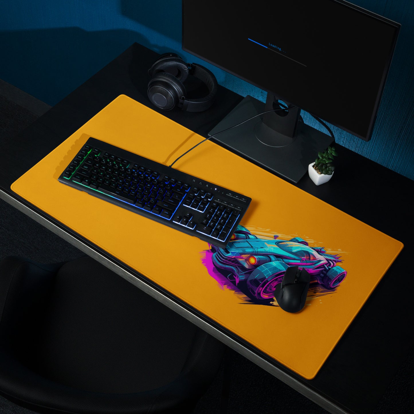 A 36" x 18" desk pad with a futuristic race car displayed on the right shown on a desk setup. Orange in color.