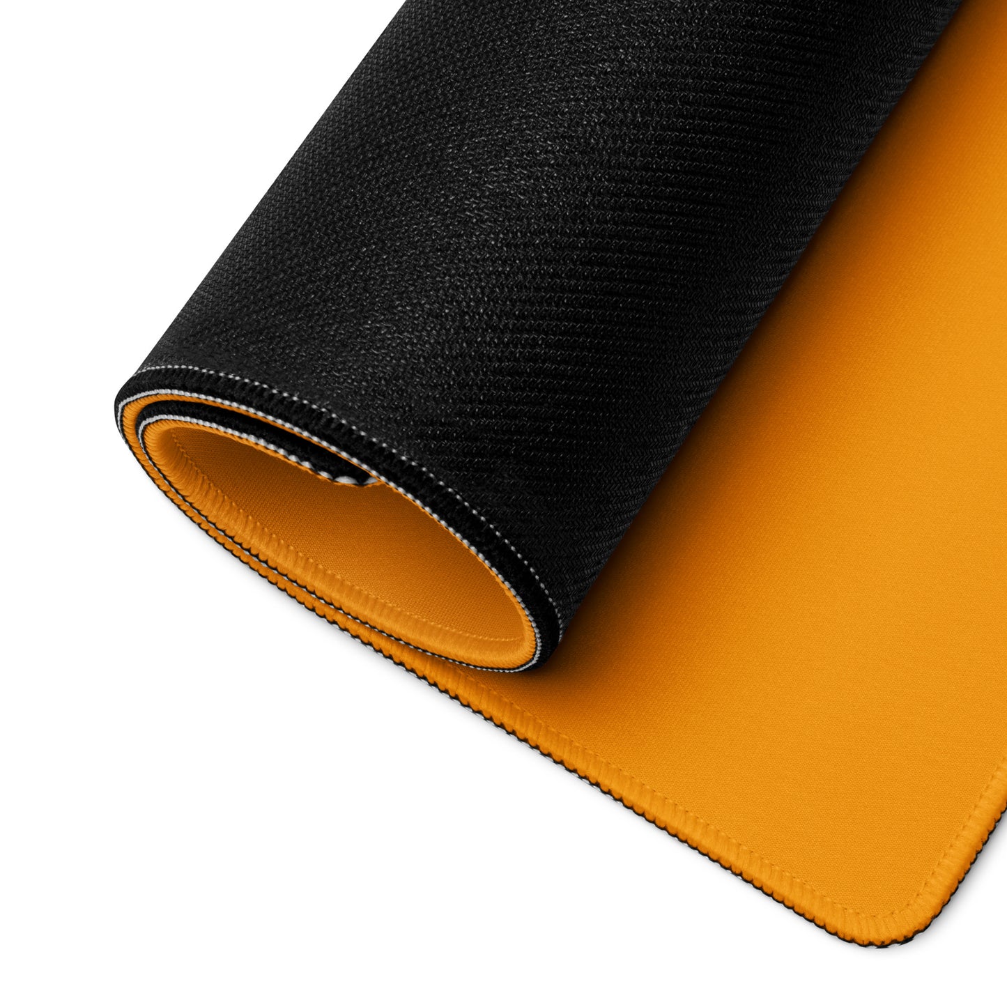 A desk pad with a futuristic race car displayed rolled up. Orange in color.
