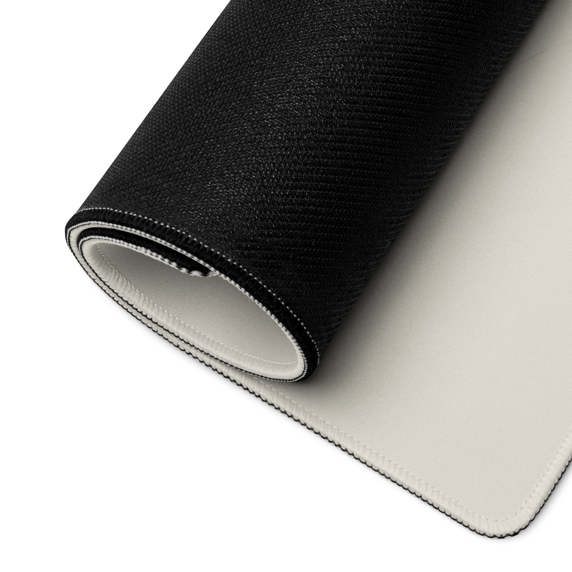 A desk pad with two fast formula one cars on the sides rolled up. Beige in color.