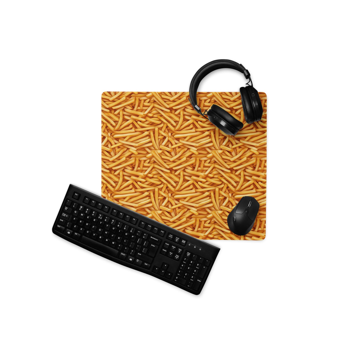A 18" x 16" desk pad with a bunch of french fries all over it displayed with a keyboard, headphones and a mouse. Yellow in color.