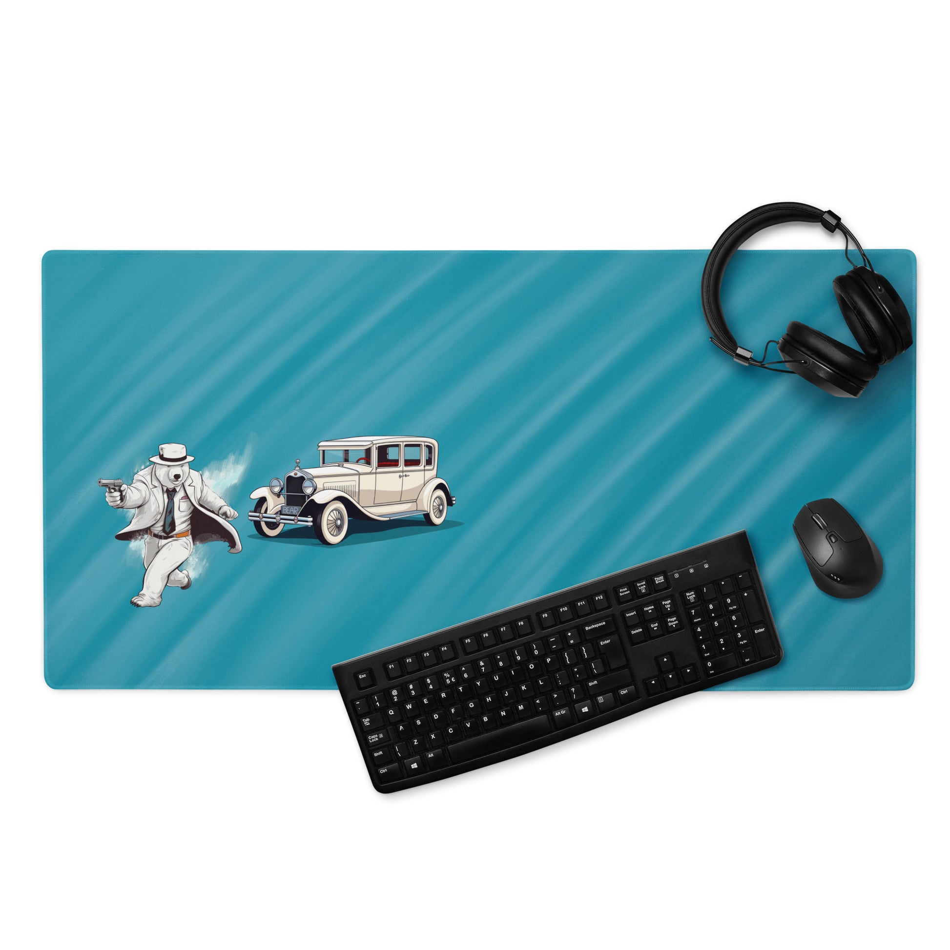 A 36" x 18" desk pad with a gangster polar bear and his car on the left displayed with headphones, a keyboard and a mouse on it. Blue in color.