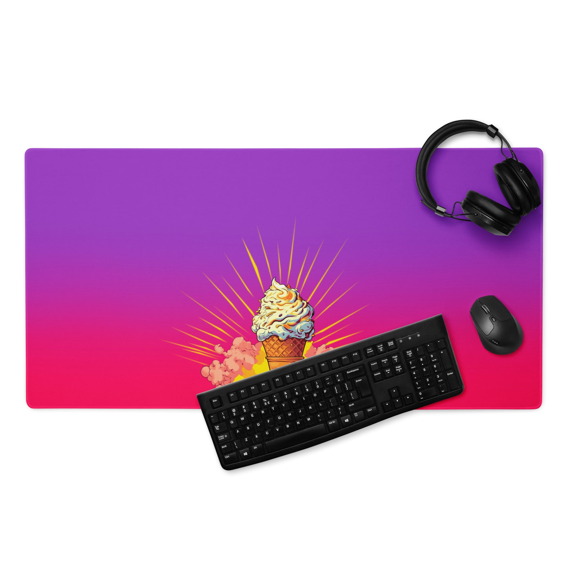 A 36" x 18" desk pad with a brightly colored ice cream cone in the middle of it displayed with a keyboard, headphones and a mouse. Pink and purple in color.