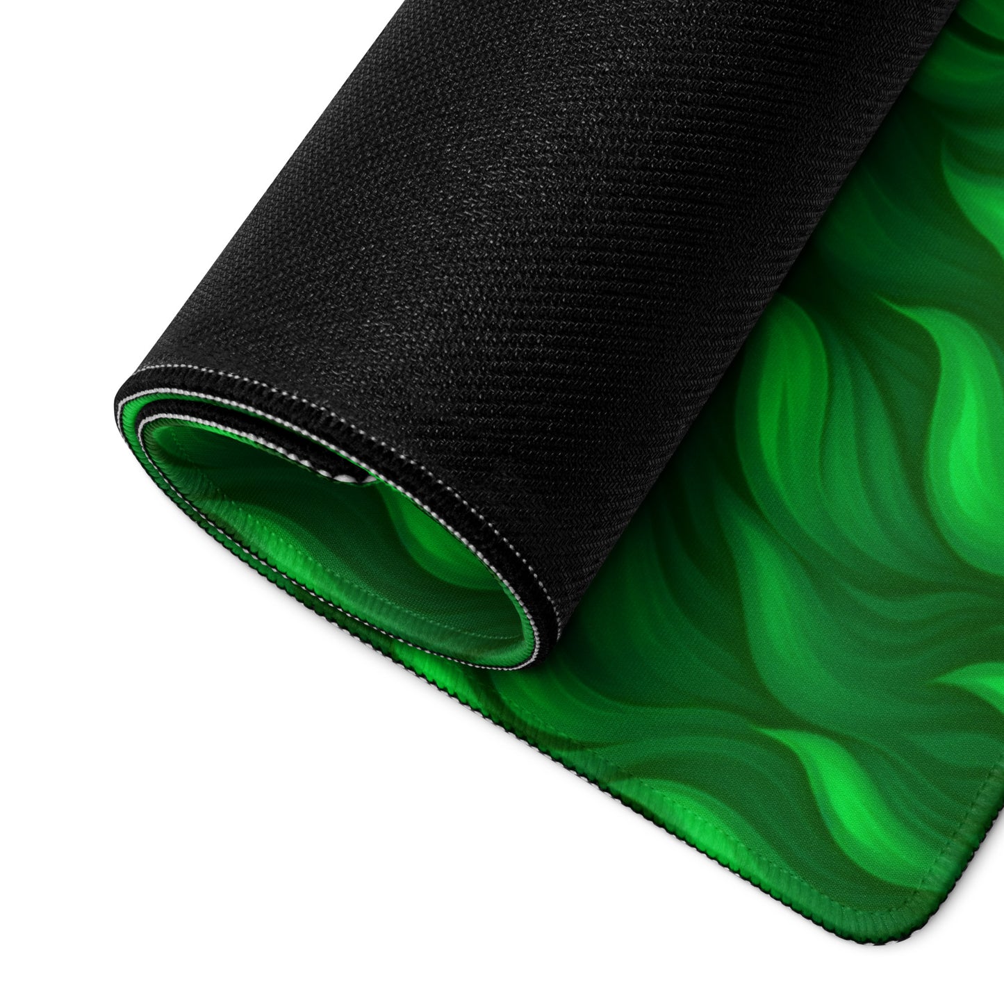 A 36" x 18" desk pad with a wavy flame pattern on it rolled up. Green in color.