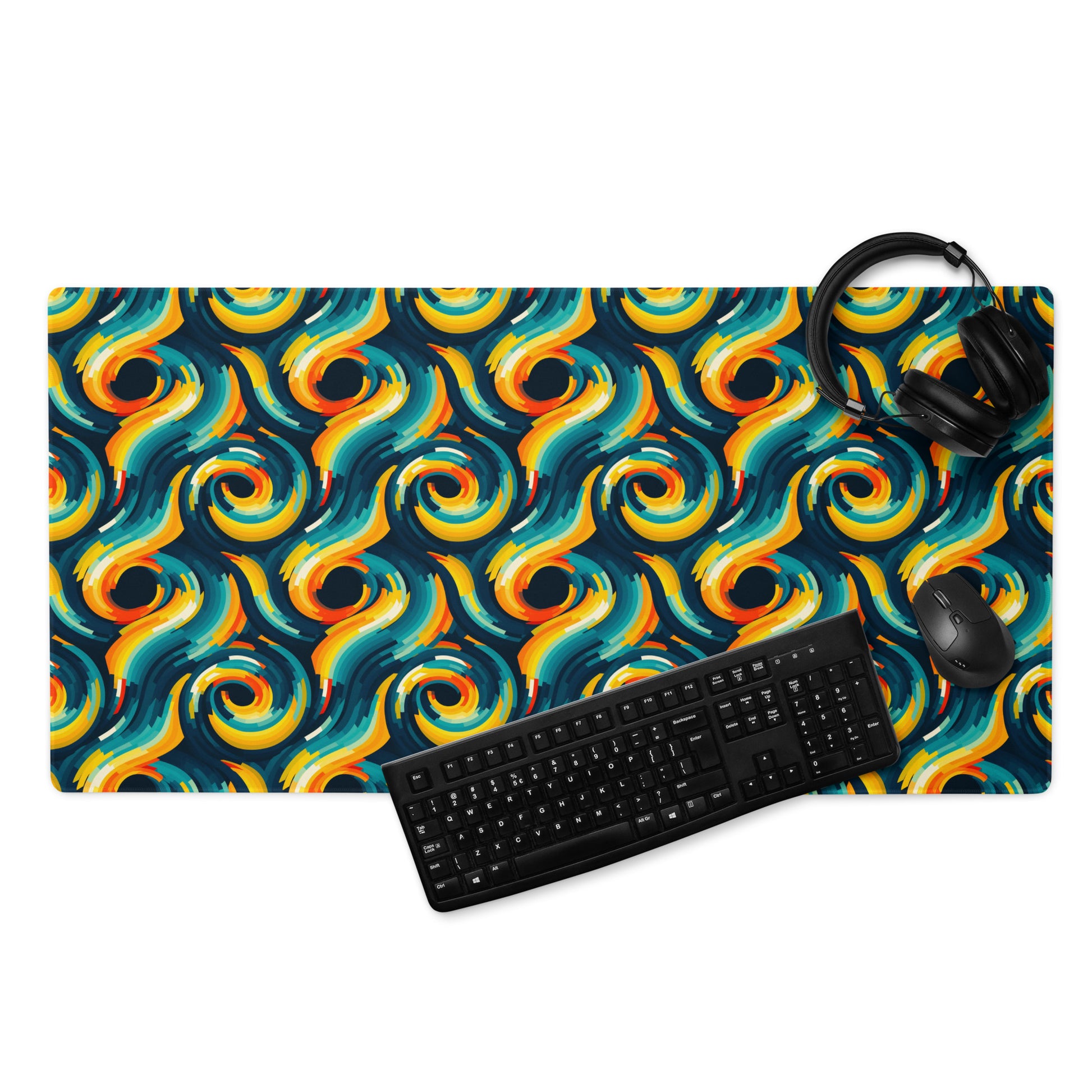  A 36" x 18" desk pad with swirls all over it displayed with a keyboard, headphones and a mouse. Yellow and Blue in color.