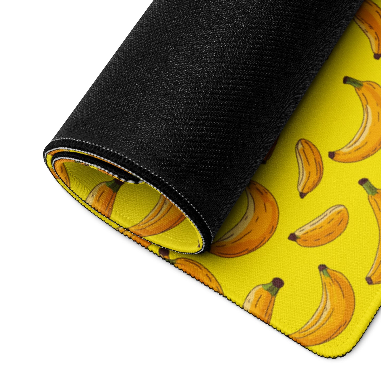 A 36" x 18" desk pad with bananas all over it rolled up. Yellow in color.