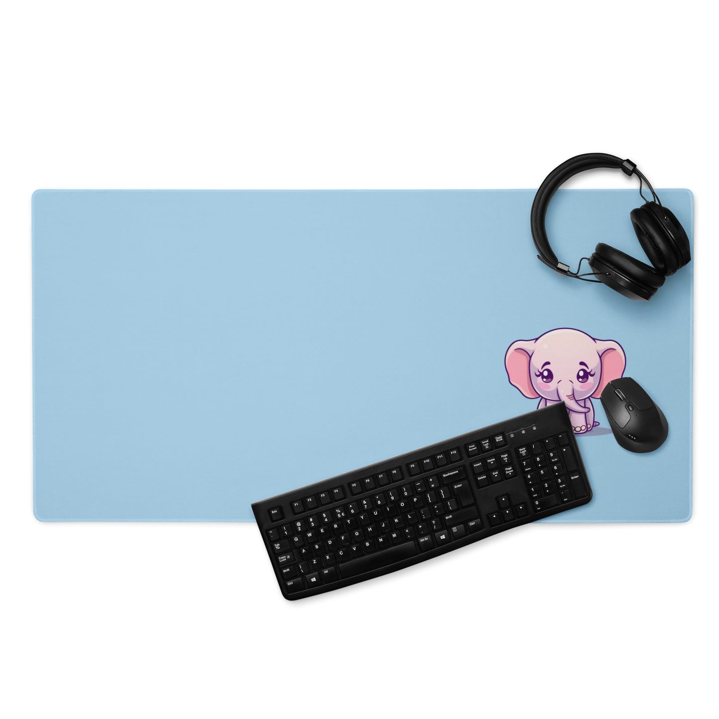 A 36" x 18" desk pad with a cute elephant on it displayed with a keyboard, headphones and a mouse. Blue in color.