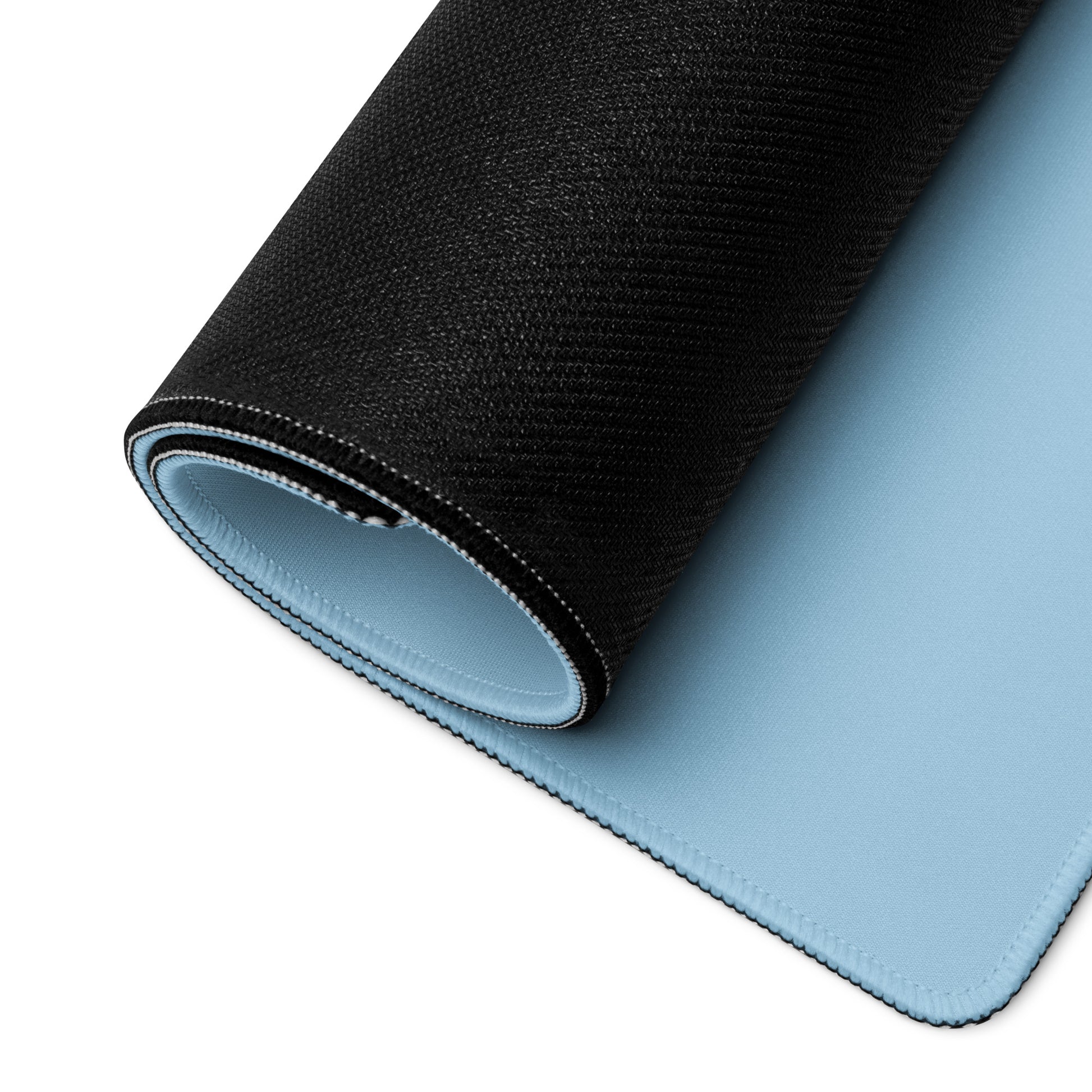 A 36" x 18" desk pad with a cute elephant on it rolled up. Blue in color.