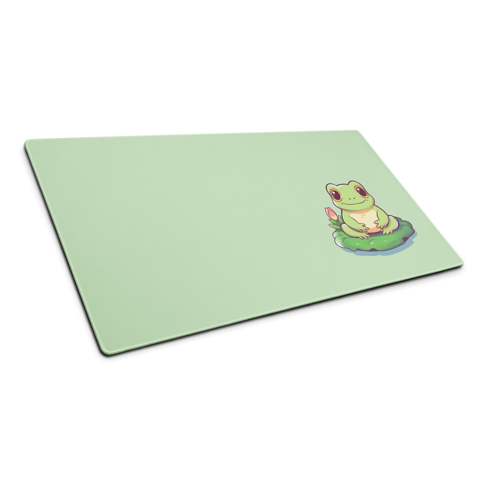 A 36" x 18" desk pad with a cute frog on it shown at an angle. Green in color.