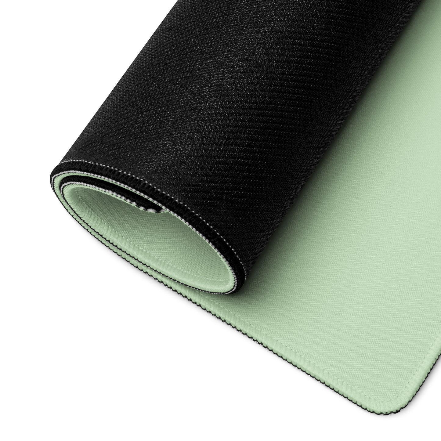 A 36" x 18" desk pad with a cute frog on it rolled up. Green in color.