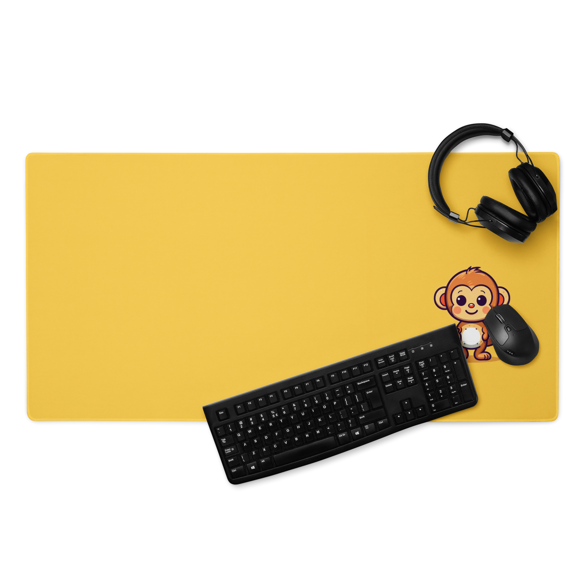A 36" x 18" desk pad with a cute monkey holding bananas displayed with headphones, a keyboard and a mouse on it. Yellow in color.