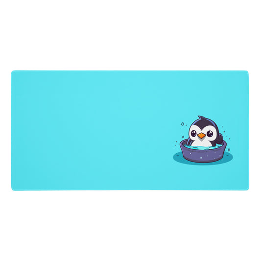  36" x 18" desk pad with a cute penguin sitting in an ice bath on it. Blue in color.