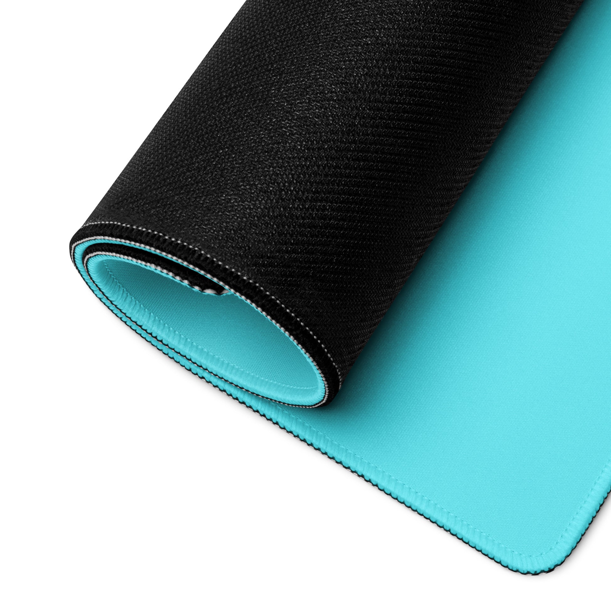 36" x 18" desk pad with a cute penguin sitting in an ice bath on it rolled up. Blue in color.