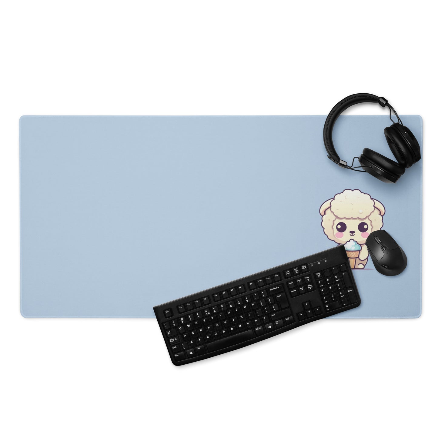 A 36" x 18" desk pad with a cute sheep eating ice cream on it displayed with a keyboard, headphones and a mouse. Blue in color.
